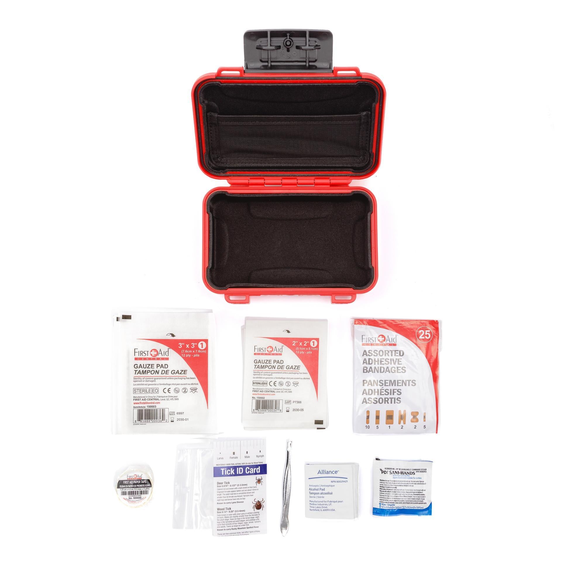 First aid kit with open red case and contents on a white background First aid kit with open red case and contents on a white background
