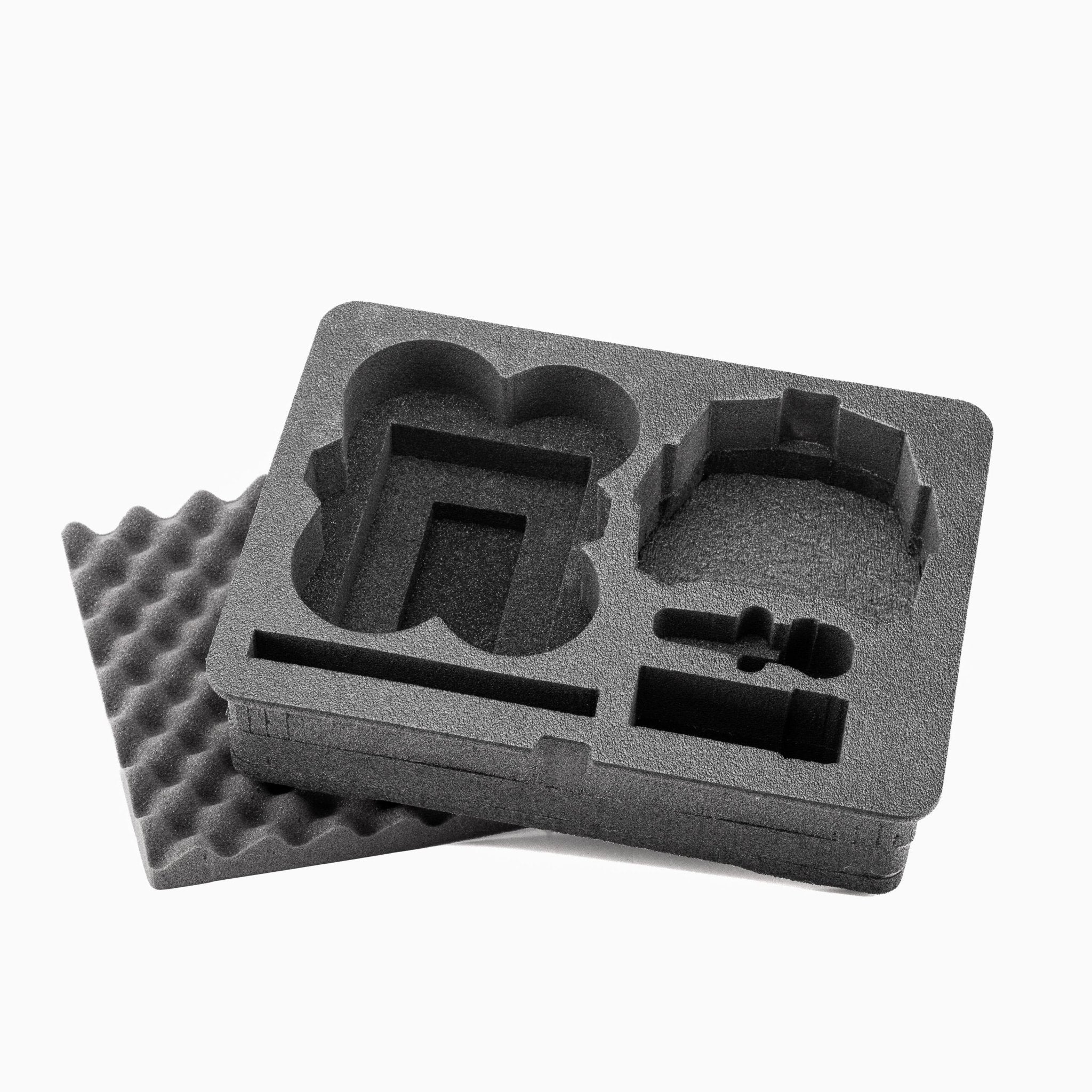 Gray foam packaging tray with cutouts on a white background Gray foam packaging tray with cutouts on a white background