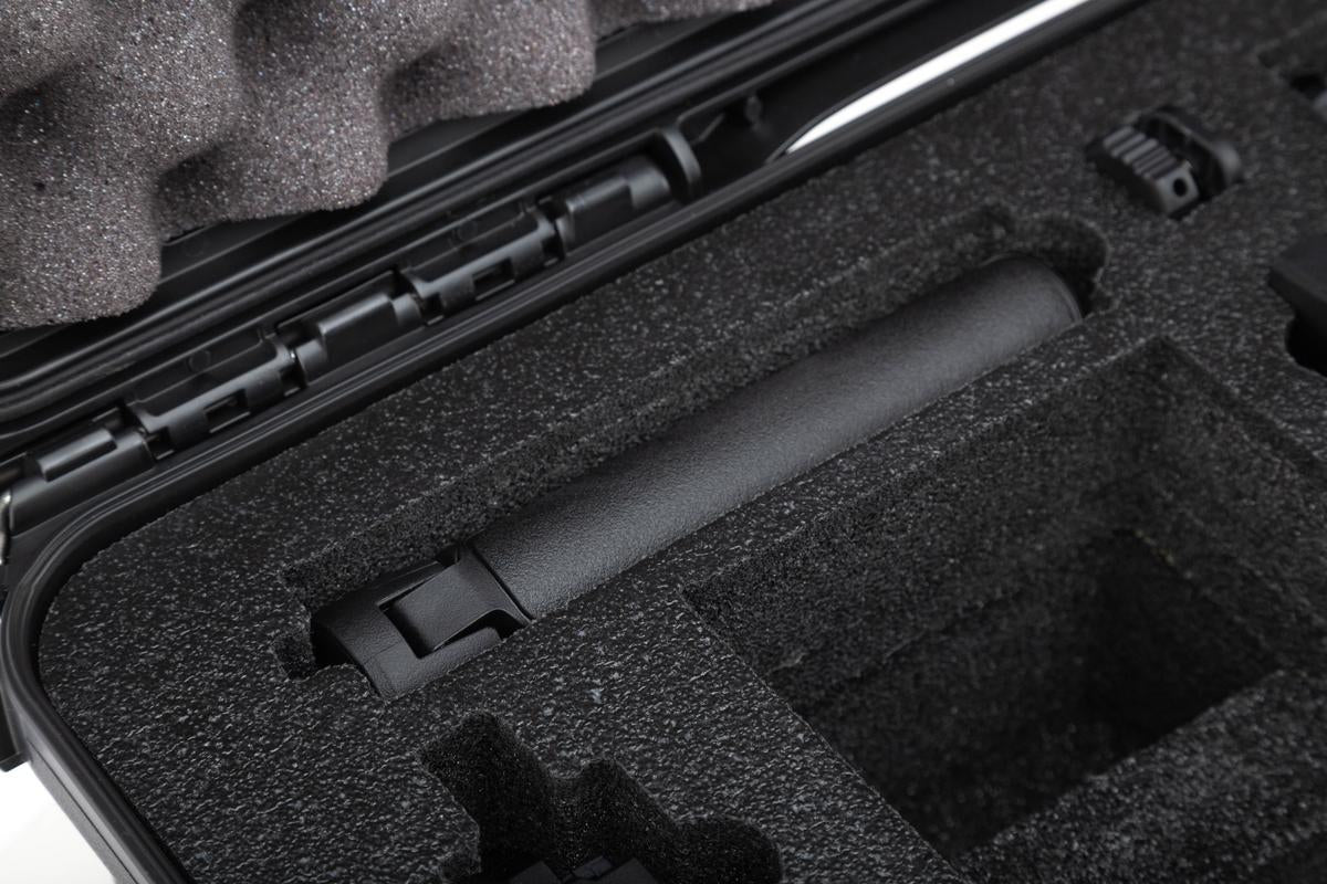 Black foam-lined protective case with a cylindrical object inside
