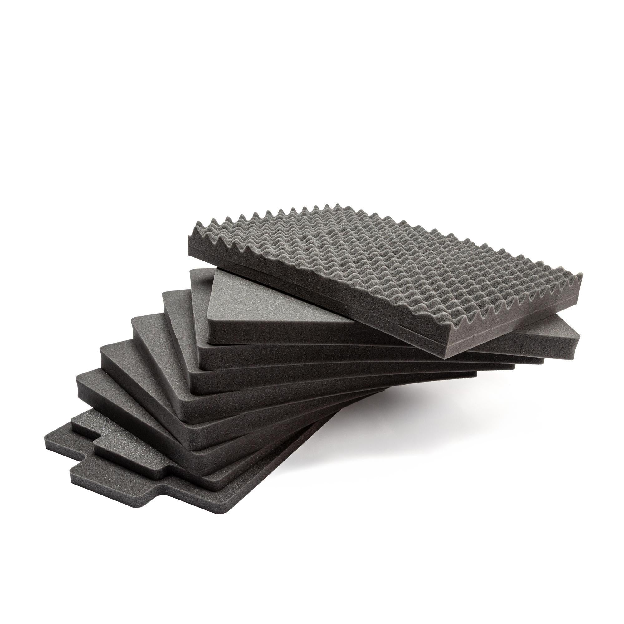 Stack of gray foam tiles on a white background Stack of gray foam tiles on a white background