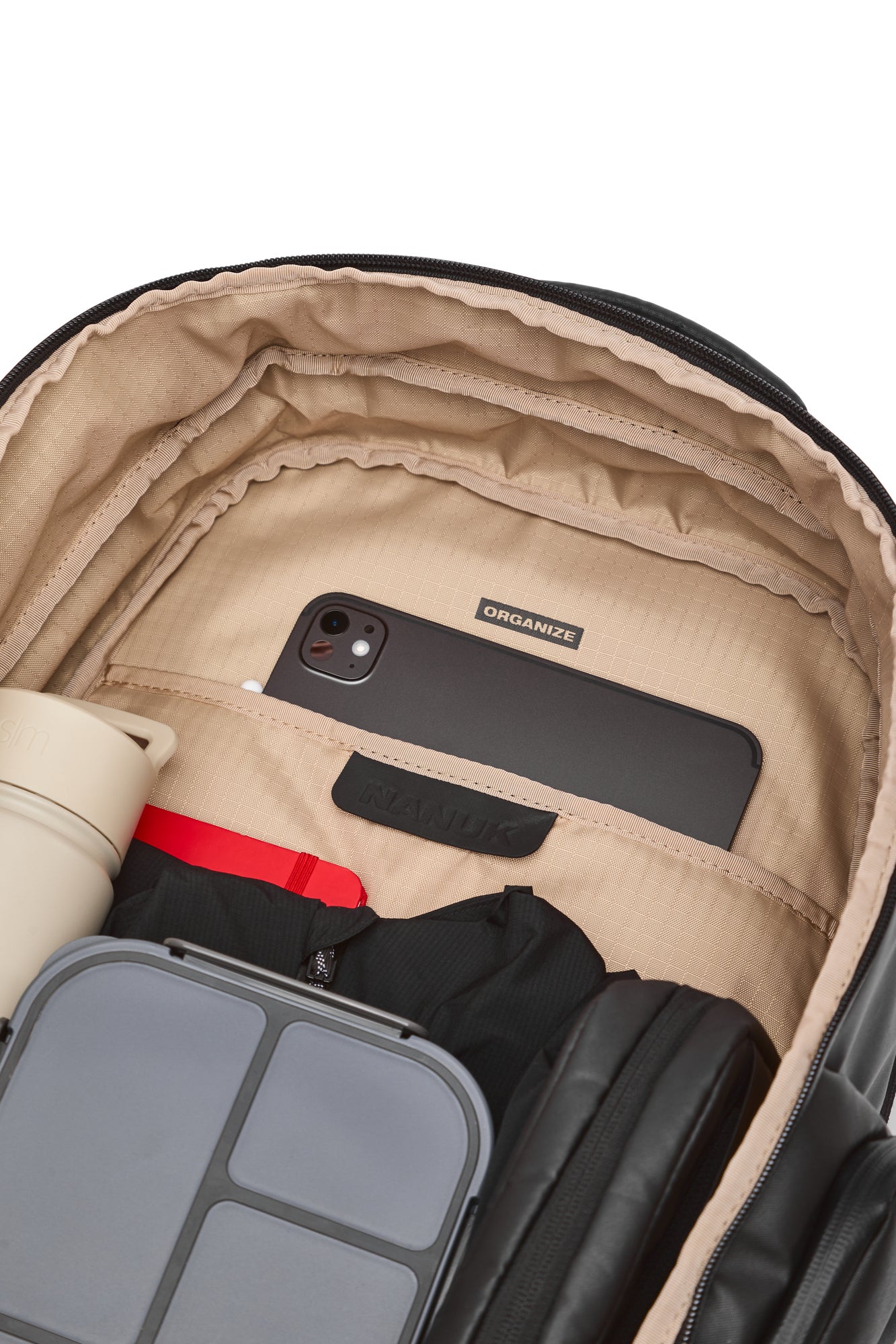 Open suitcase with a phone, water bottle, and black jacket inside on a white background Open suitcase with a phone, water bottle, and black jacket inside on a white background