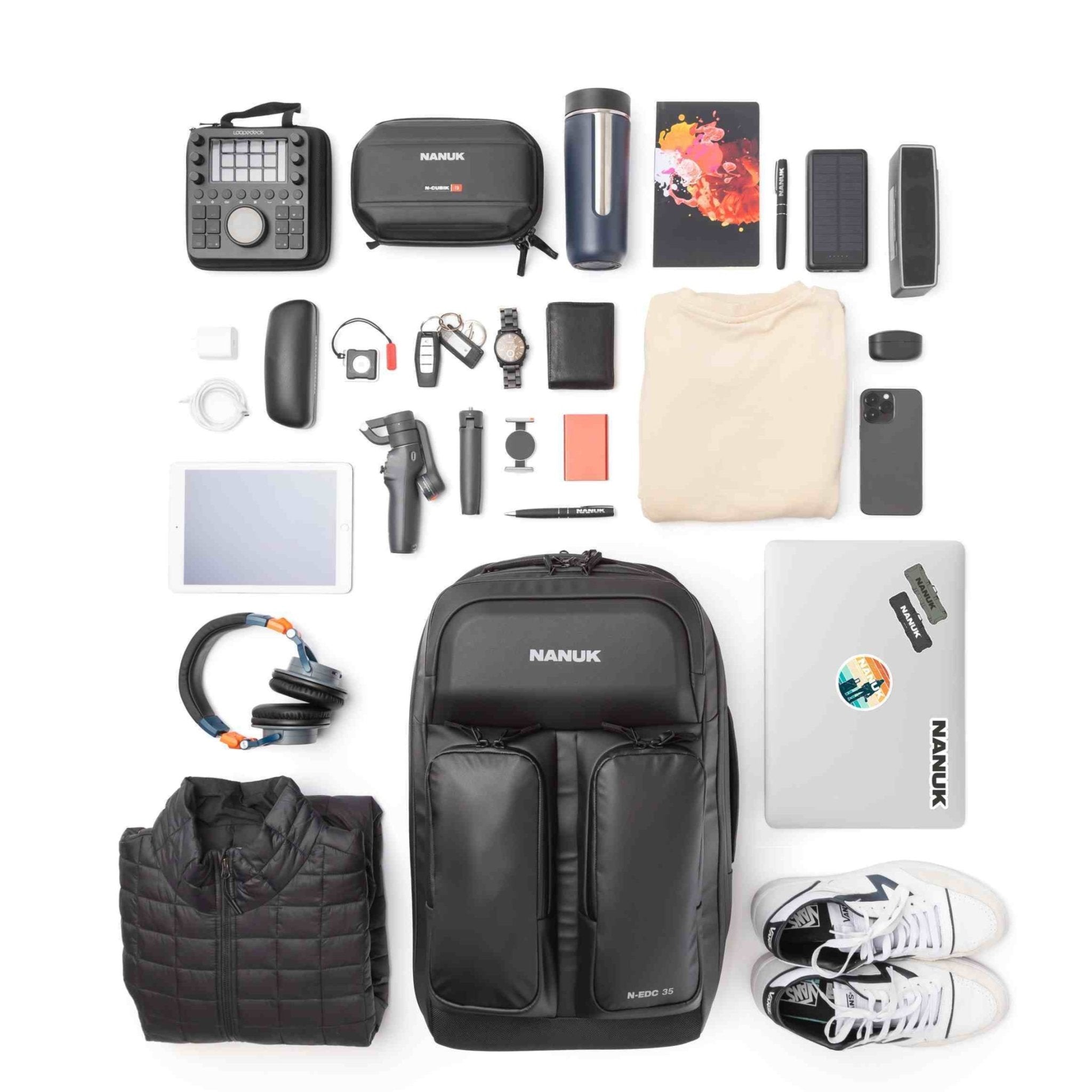 Collection of travel or adventure gear including a backpack, shoes, and electronic devices on a white background. Collection of travel or adventure gear including a backpack, shoes, and electronic devices on a white background.