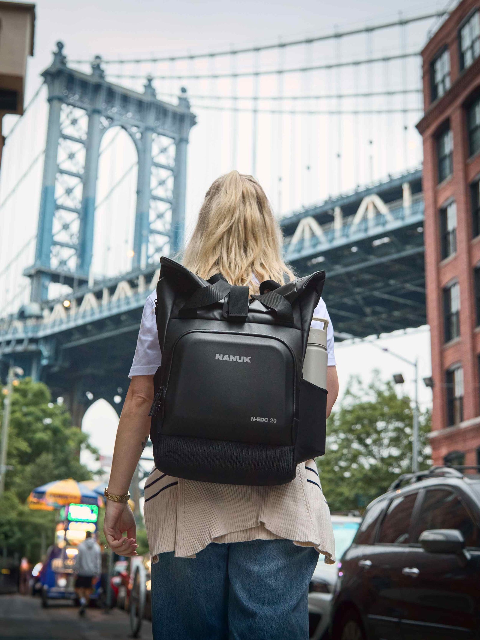Woman walking in the city with a backpack.