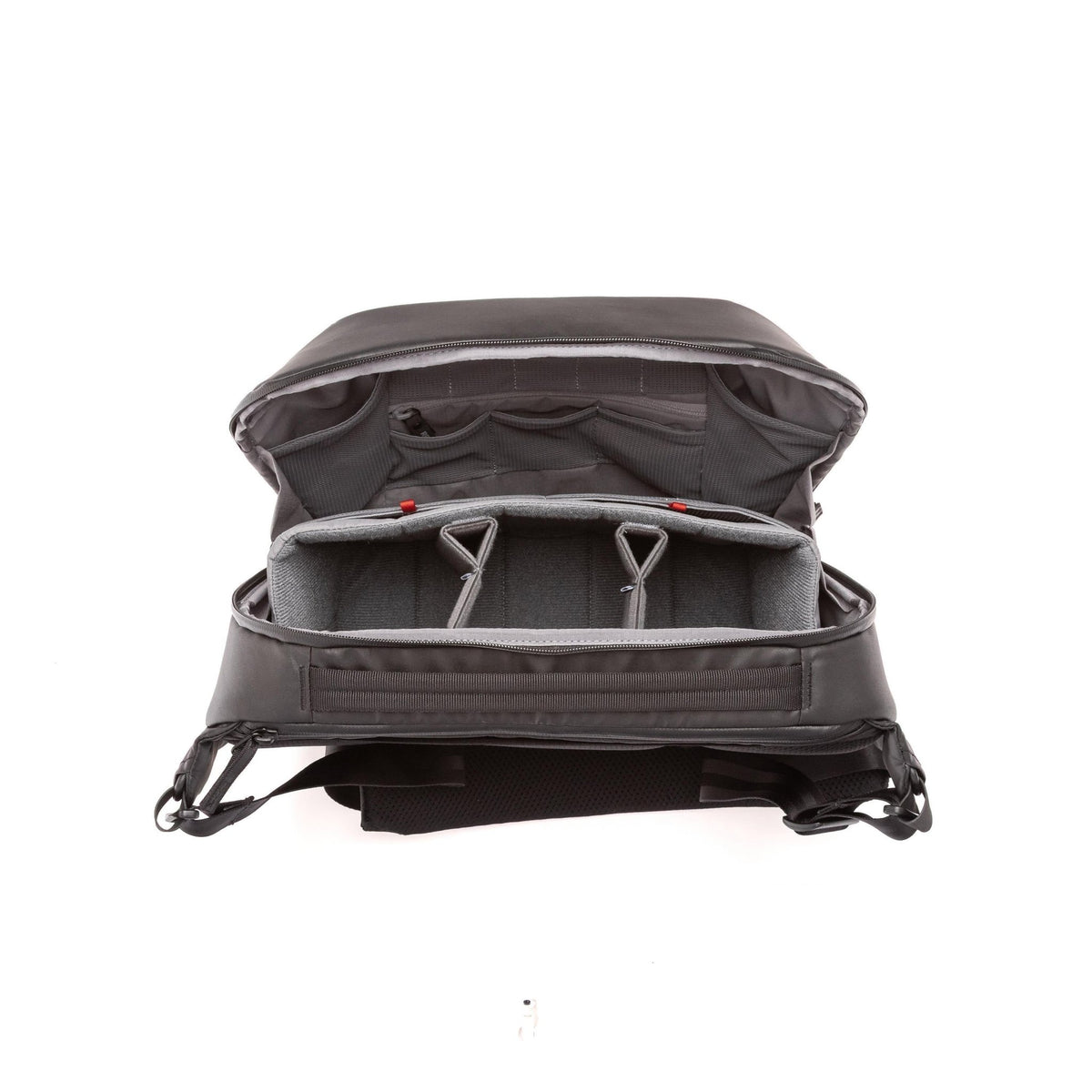 An open black camera backpack shown from the front, displaying its padded interior compartments, foam inserts, and adjustable shoulder straps against a white background. An open black camera backpack shown from the front, displaying its padded interior compartments, foam inserts, and adjustable shoulder straps against a white background.