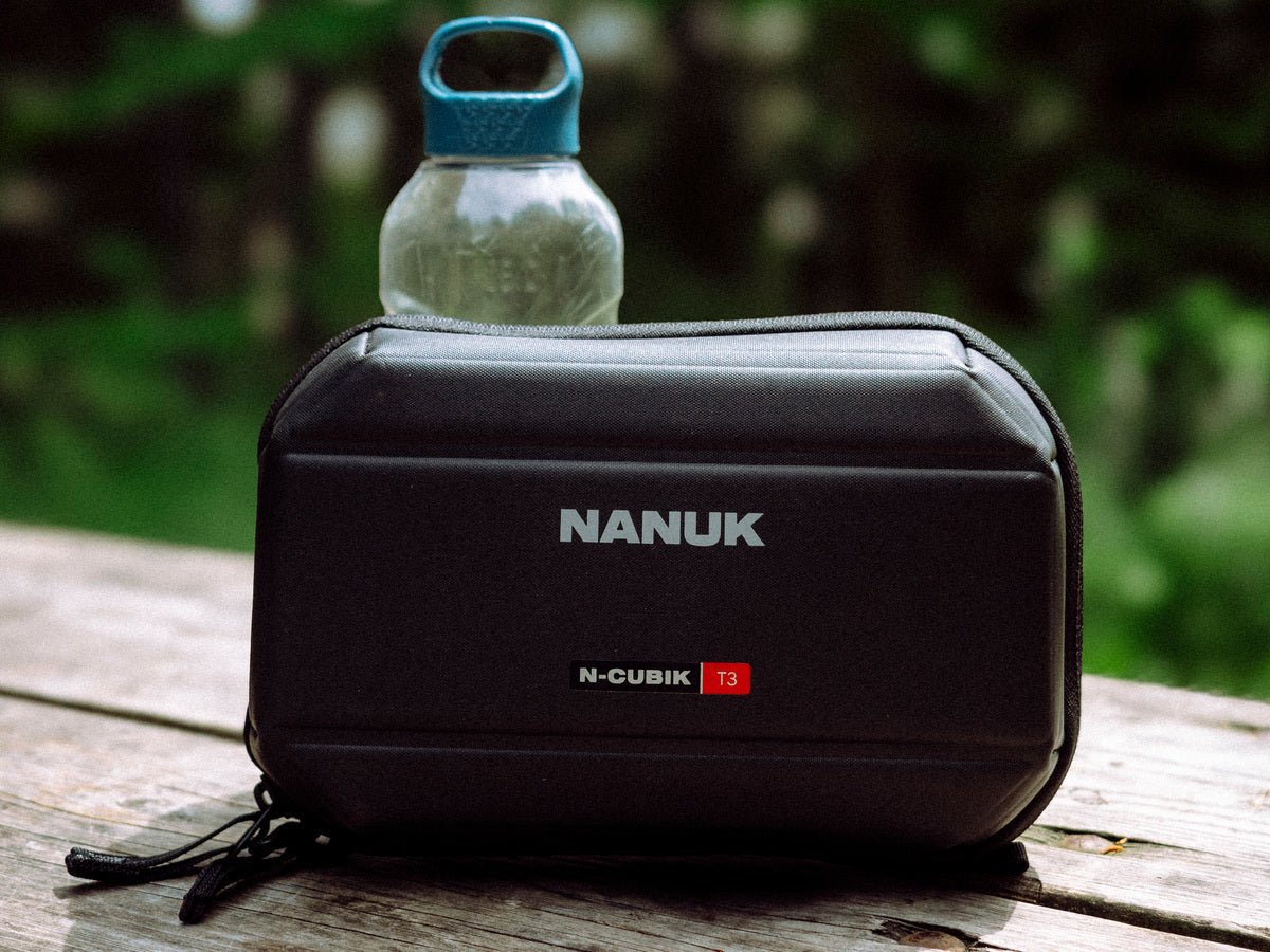 N-Cubik_Techpouch outdoor on a wooden table N-Cubik_Techpouch outdoor on a wooden table
