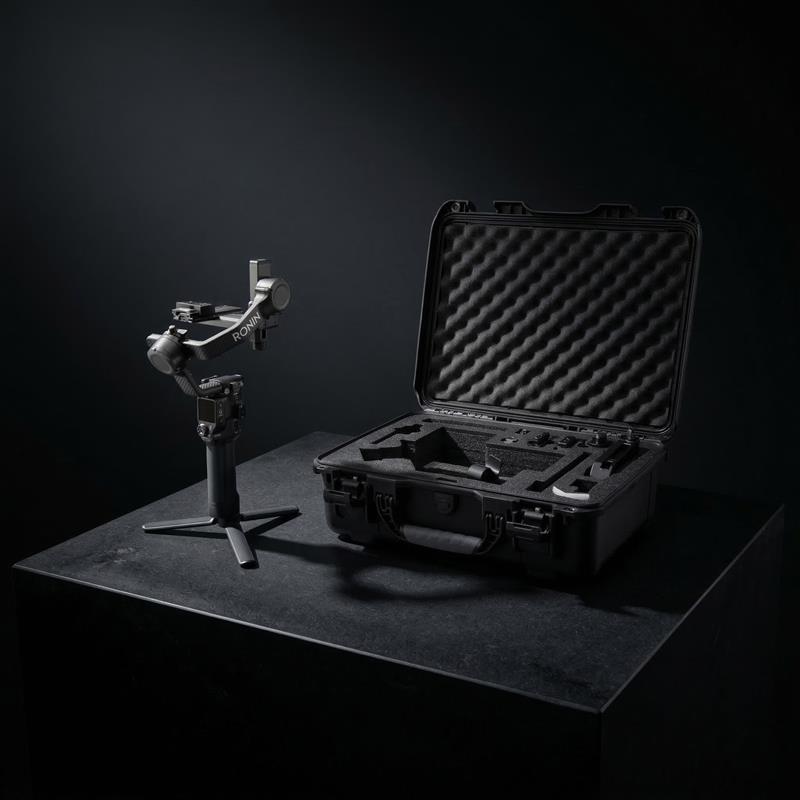 Camera stabilizer and open case on a dark surface with black background