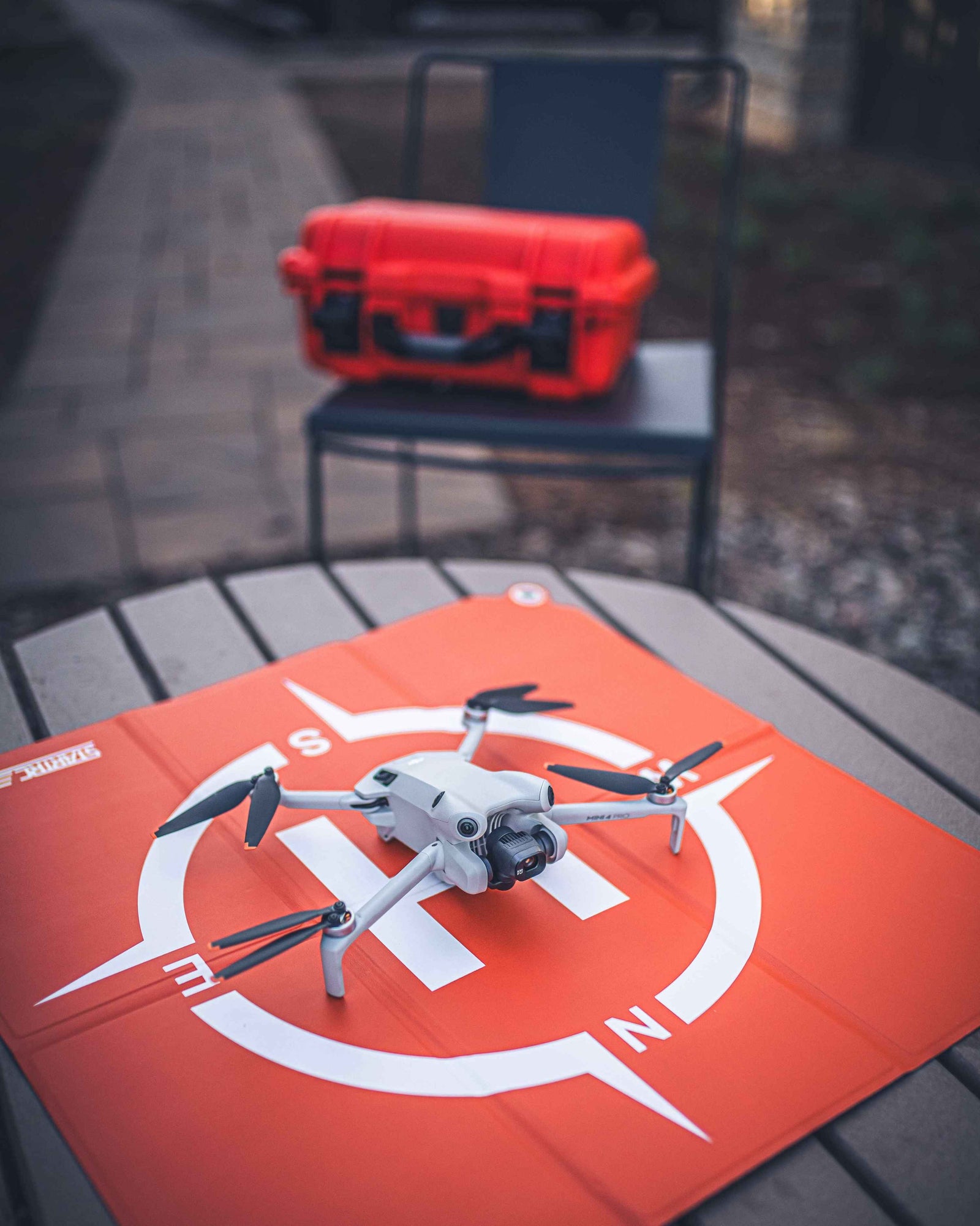 Drone on a red mat with a red case in the background
