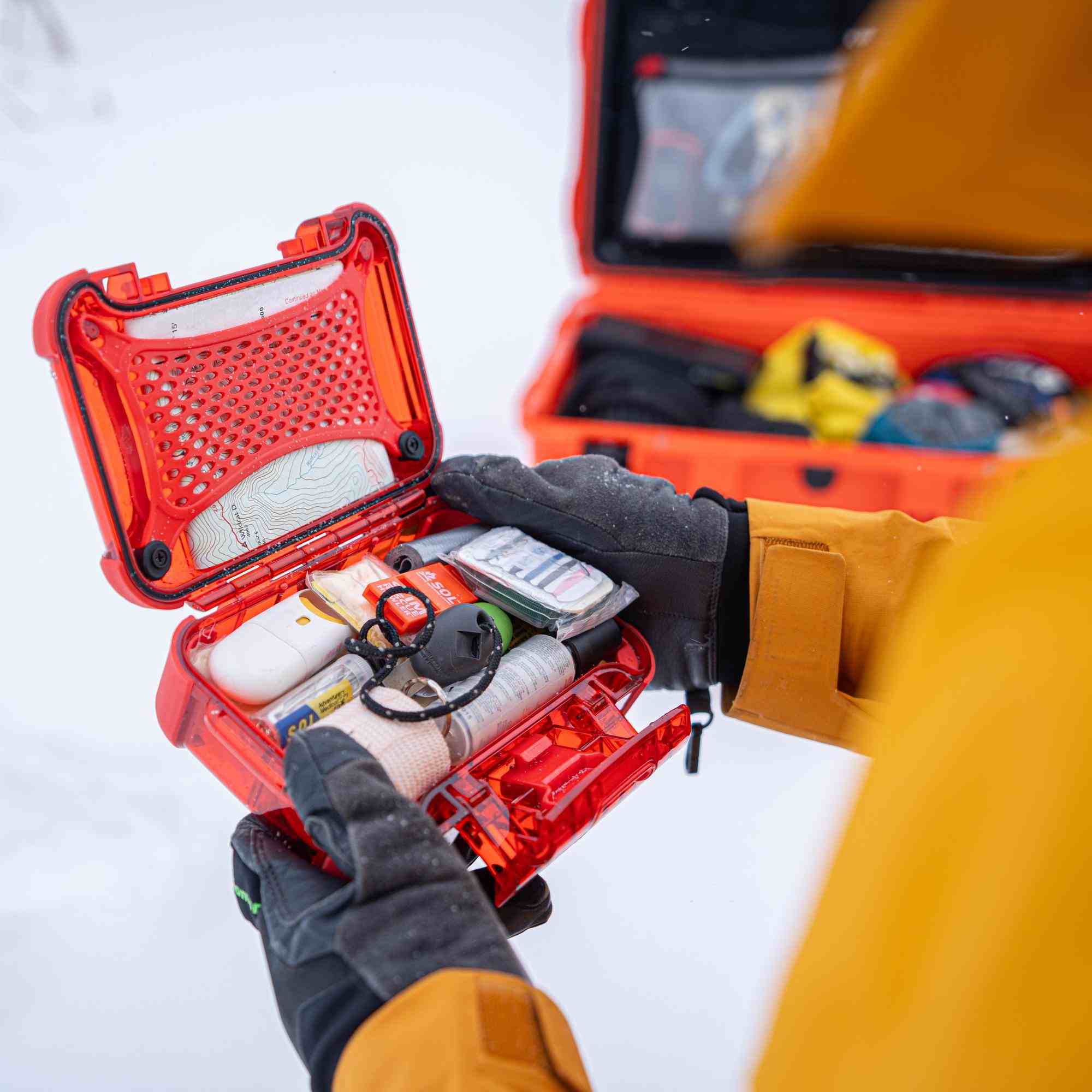 Person opening a red tool case with various items on a white background Person opening a red tool case with various items on a white background
