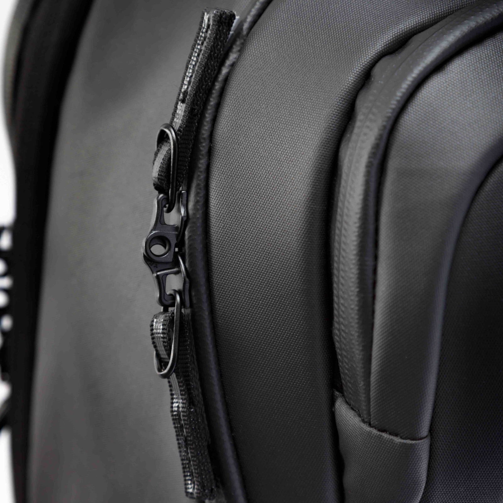 Close-up of a black backpack with a zipper detail