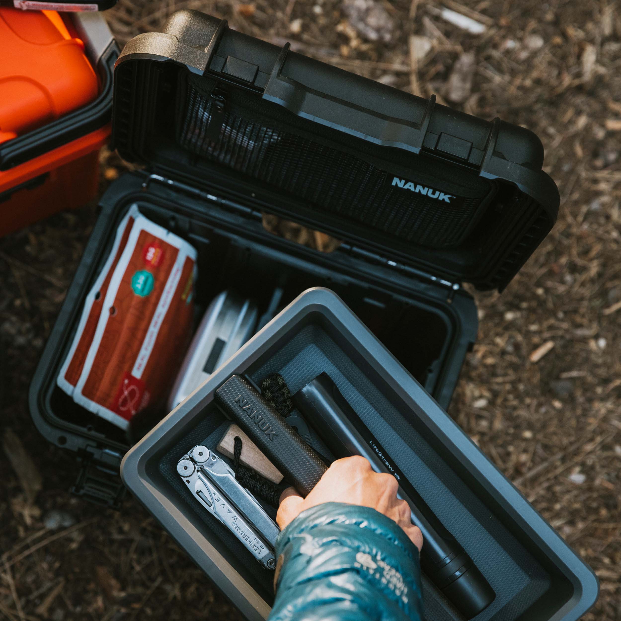 Top-down view of an open black NANUK Trail 10 case in a car trunk, showing neatly organized camera gear and accessories. Top-down view of an open black NANUK Trail 10 case in a car trunk, showing neatly organized camera gear and accessories.