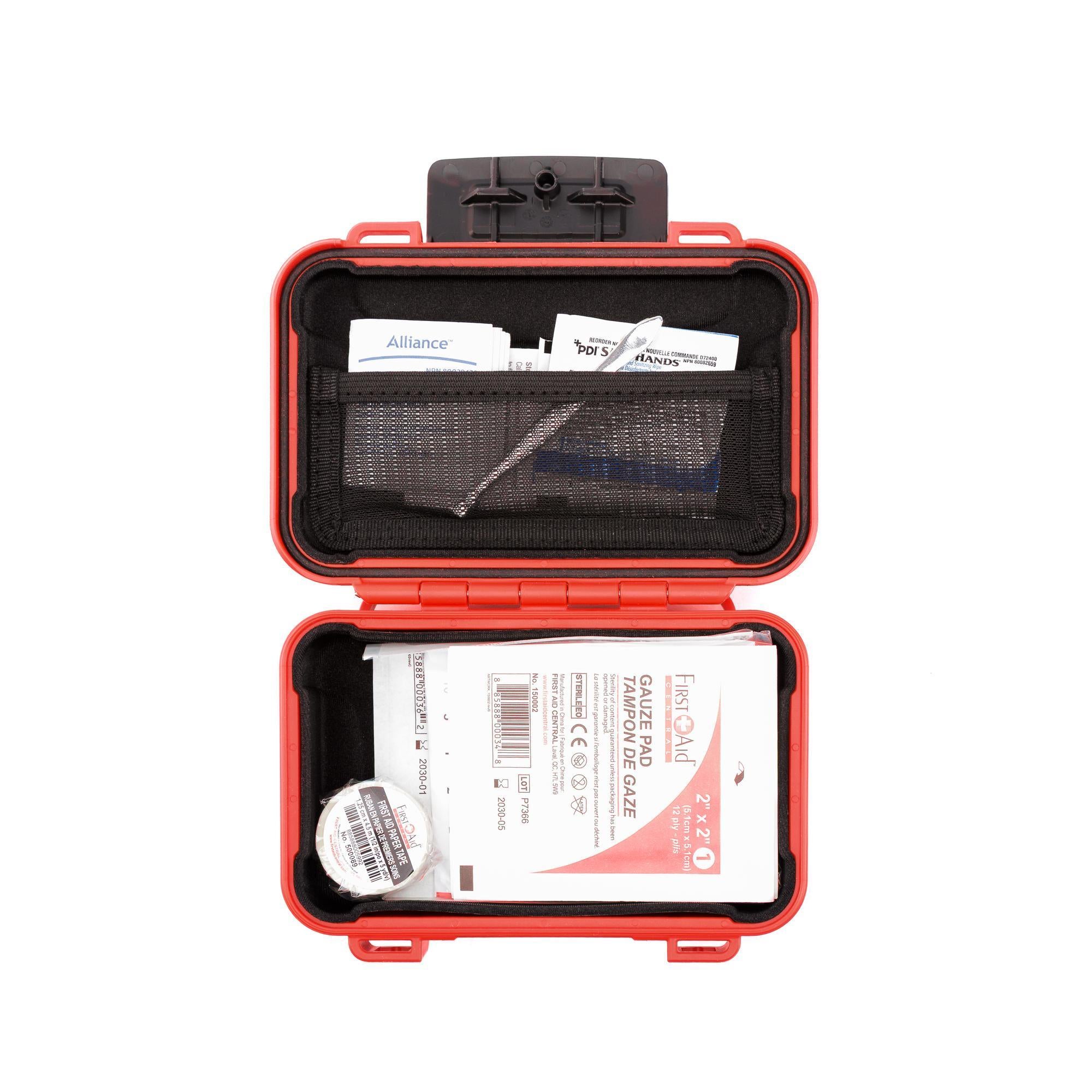 Red first aid kit with medical supplies on a white background