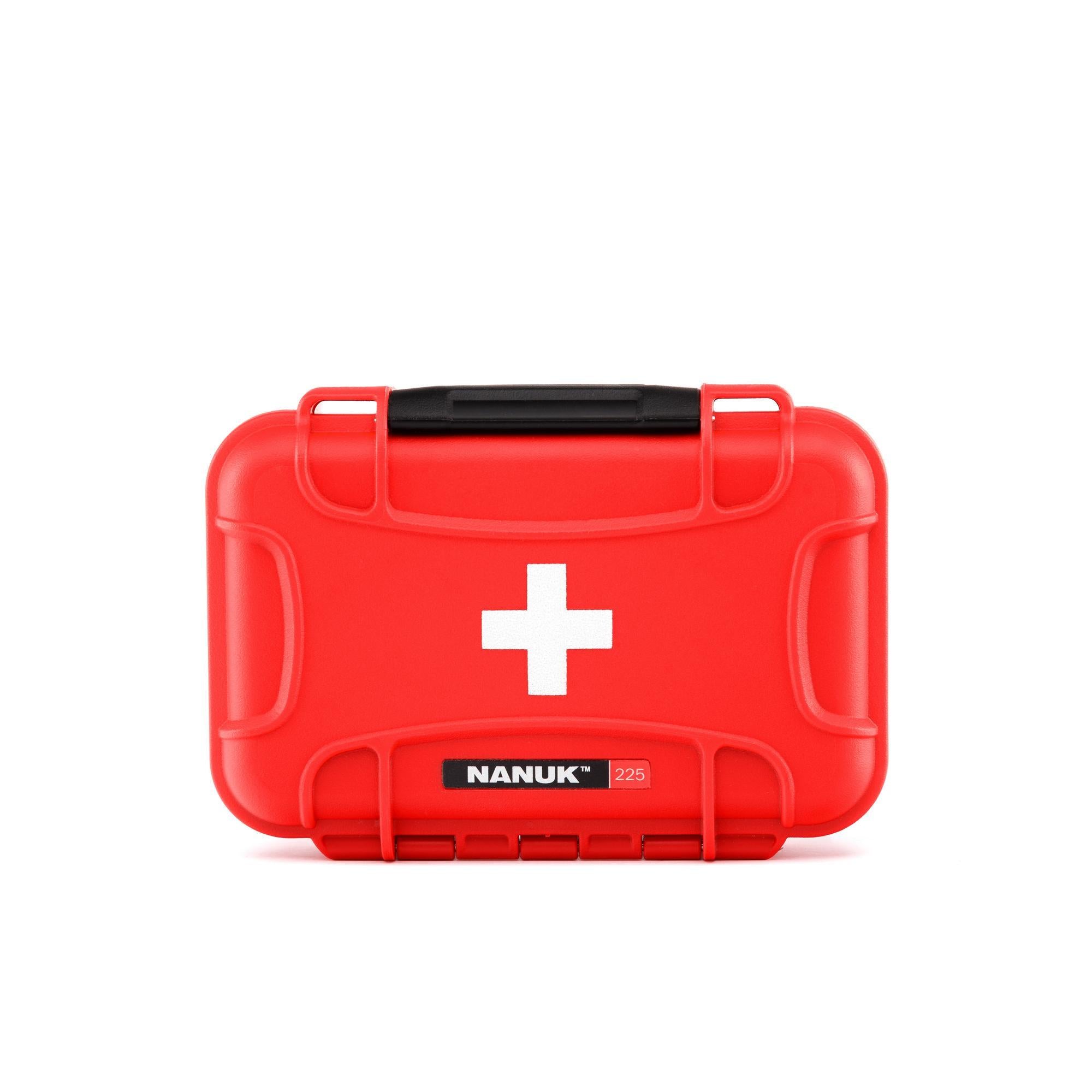 Red first aid kit with a white cross and 'Nanuk' branding on a white background