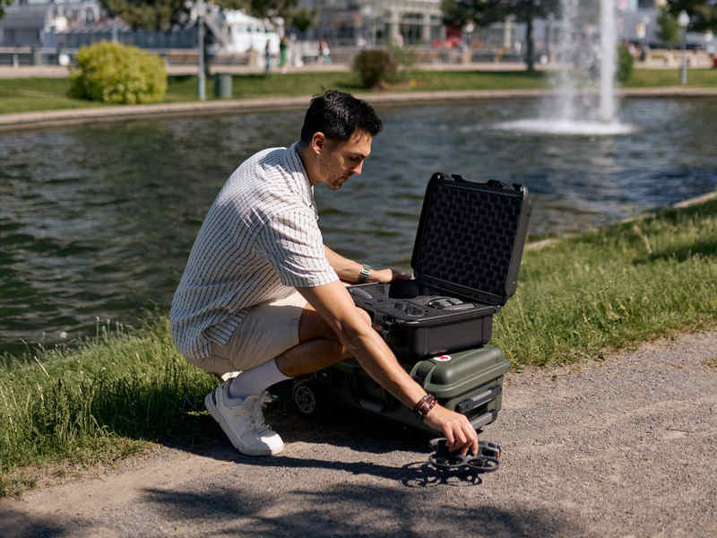 Drone user with the Nanuk 925 DJI Avata 2 Black case outdoor near a fountain