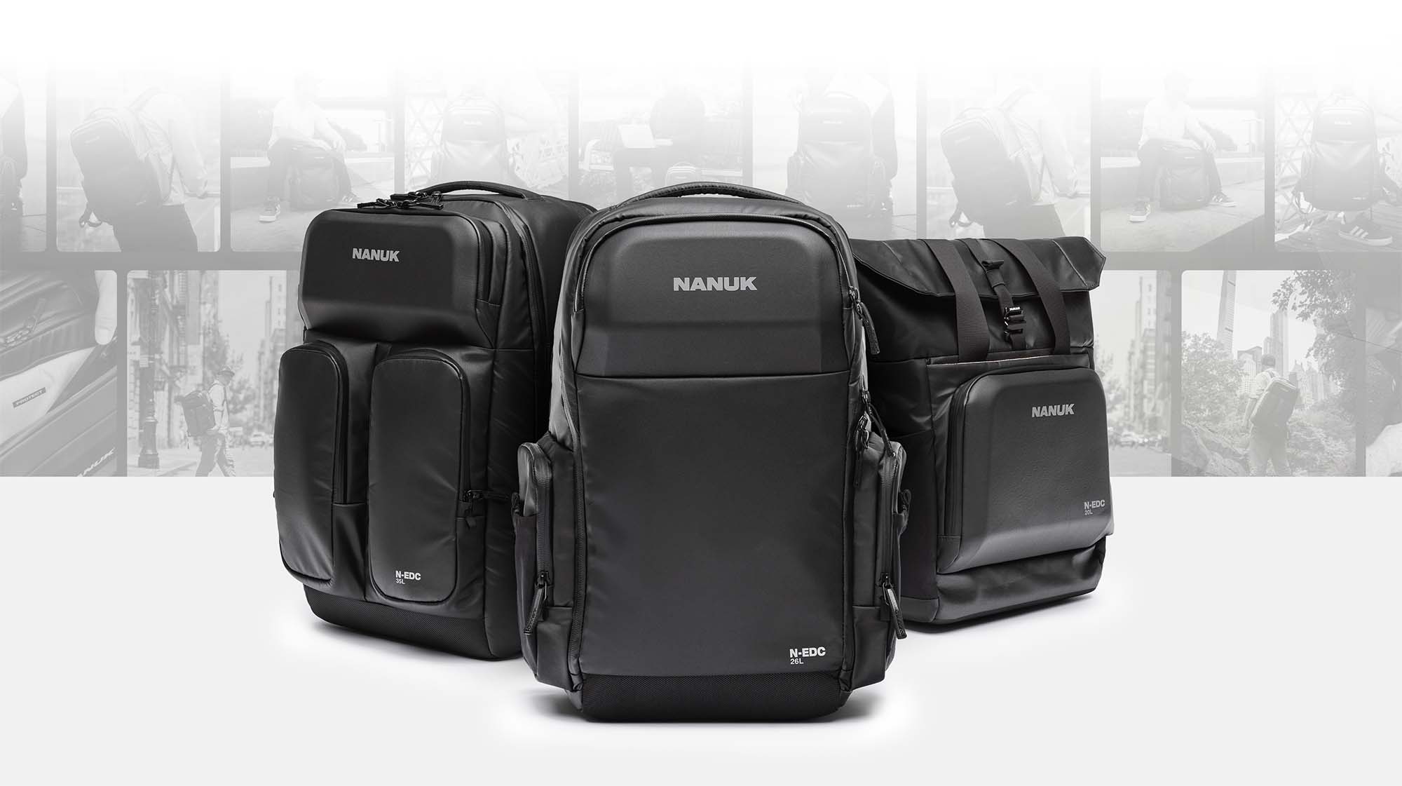 Three black Nanuk bags on a white background with blurred cityscape in the background