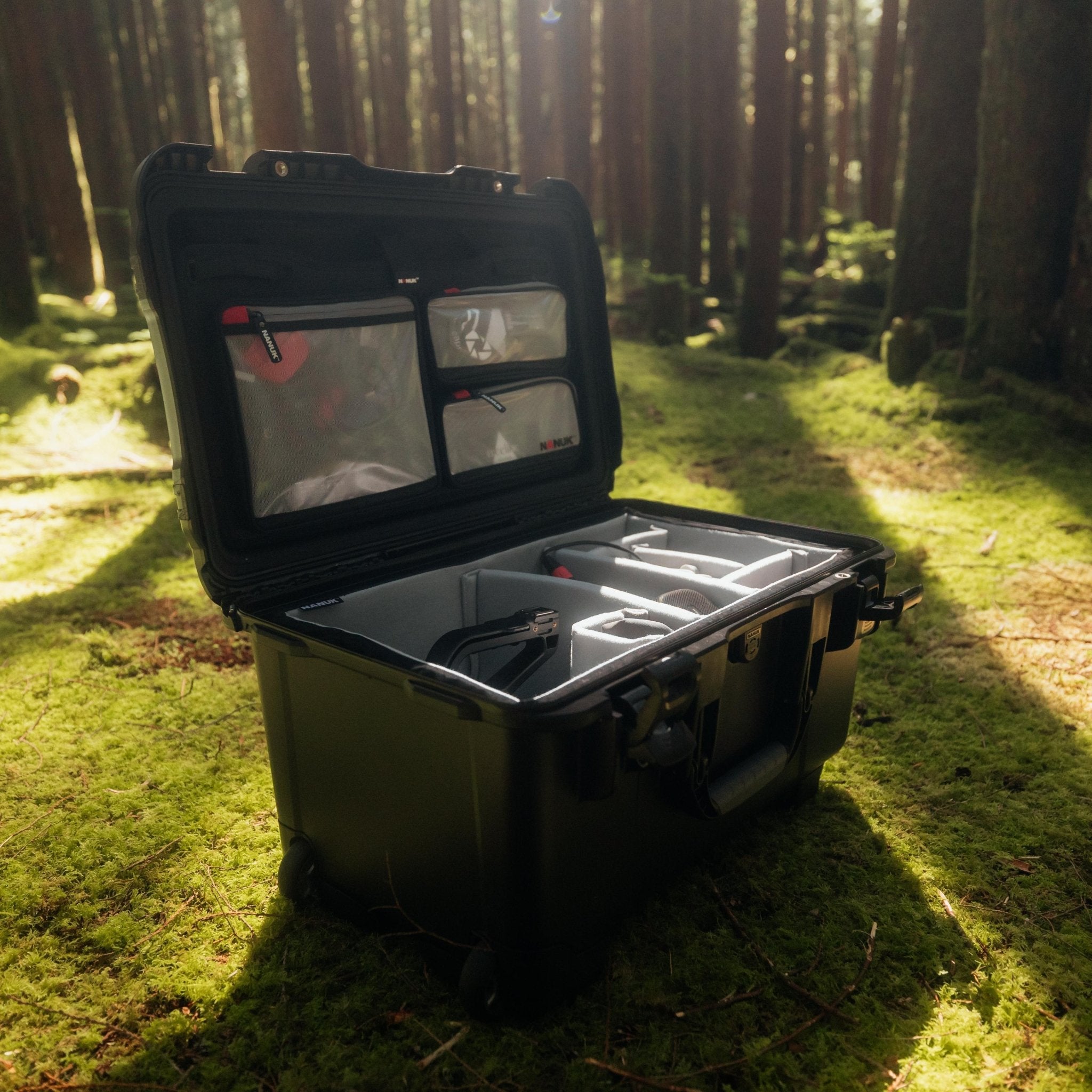 Open tool case on grass with forest background