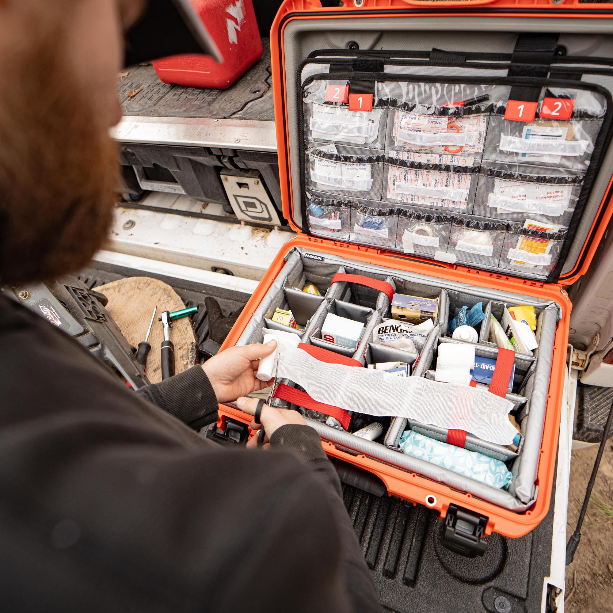 Nanuk 940 EMS Orange case sitting on a truck trunk close-up view