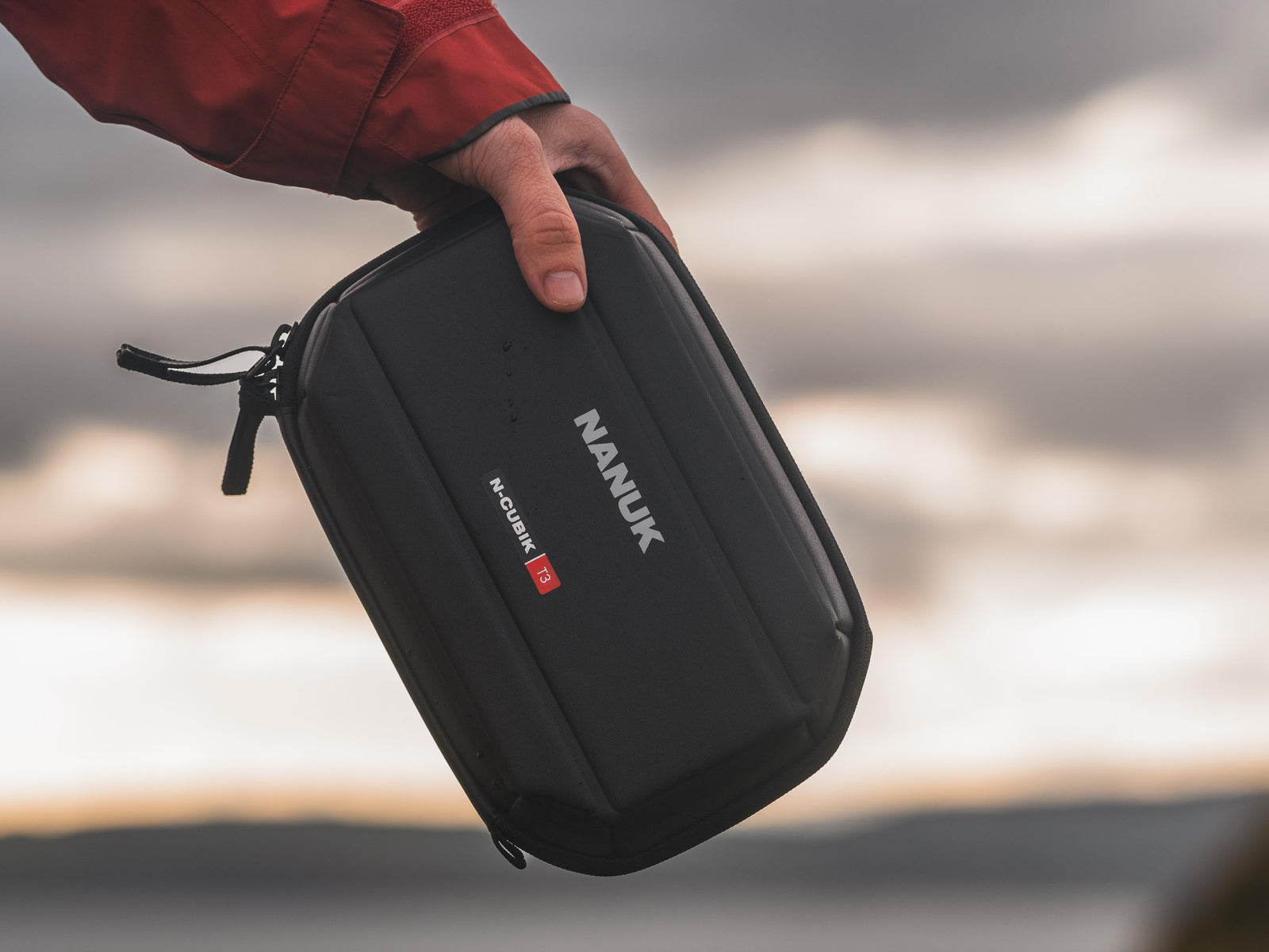 Photograph holding the Nanuk N-Cubik T3 techpouch