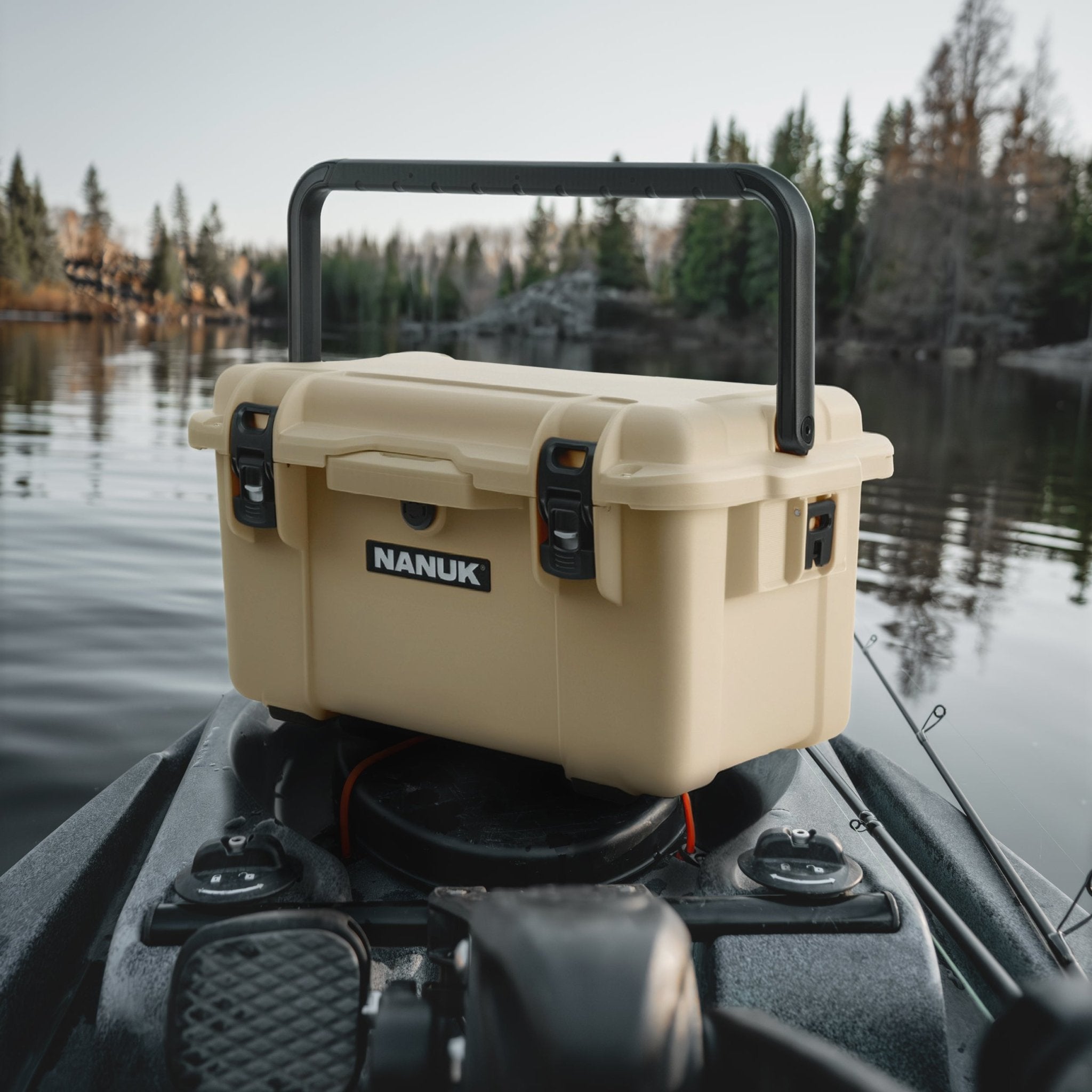 Nanuk TRAIL on a boat with a lake and trees in the background