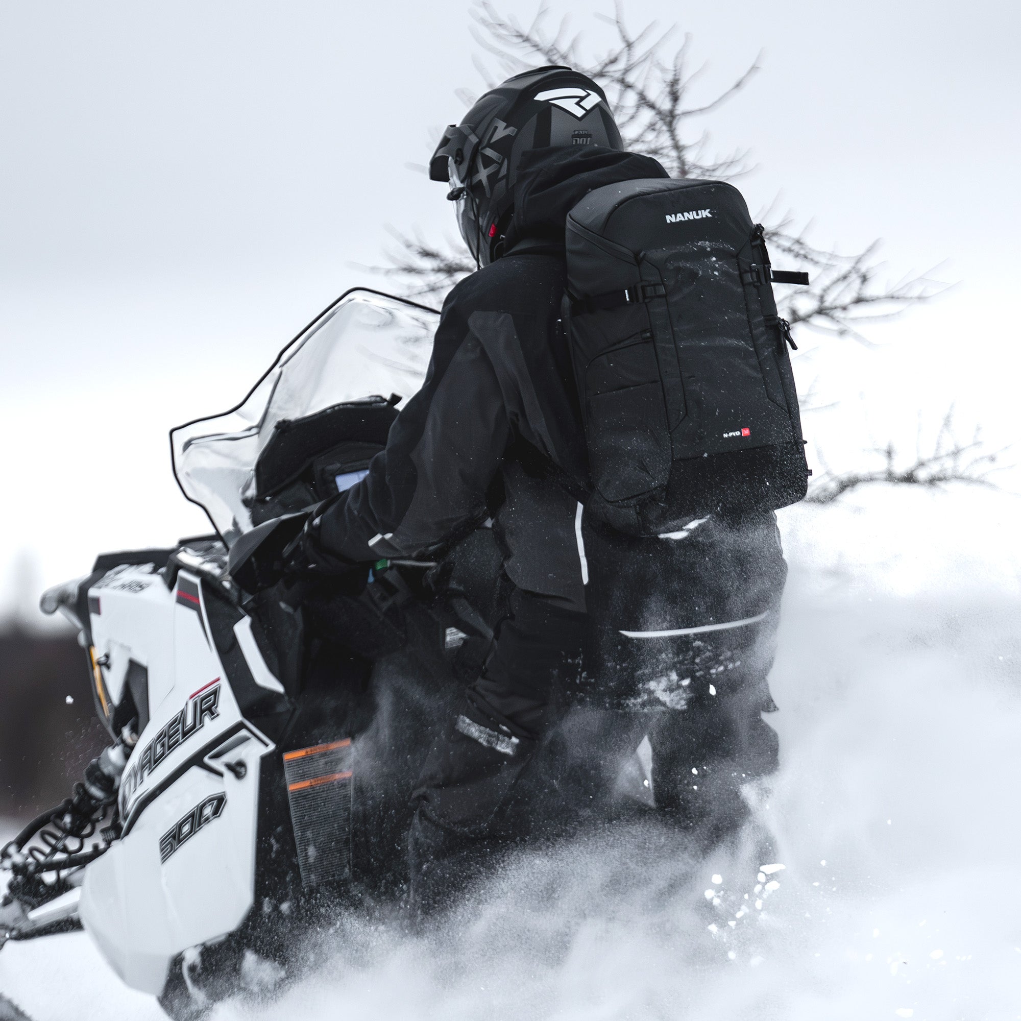 Person on a snowmobile in a snowy landscape